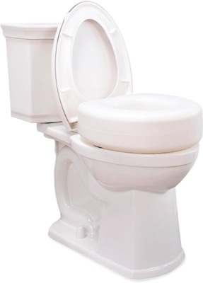 white round raised toilet seat riser fitted under the open seat of a two-piece toilet