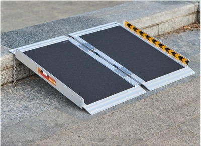 short folding aluminum wheelchair ramp with a textured silver surface and low side rails