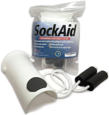 white plastic sock aid shell with two white cords and black foam handles, shown with its retail bag
