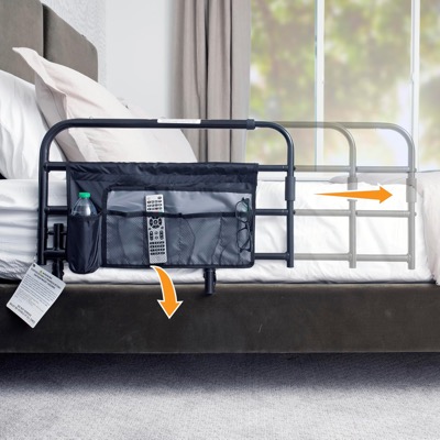 black steel bed rail with a storage pocket attached beside a mattress, with arrows showing it extending and folding down
